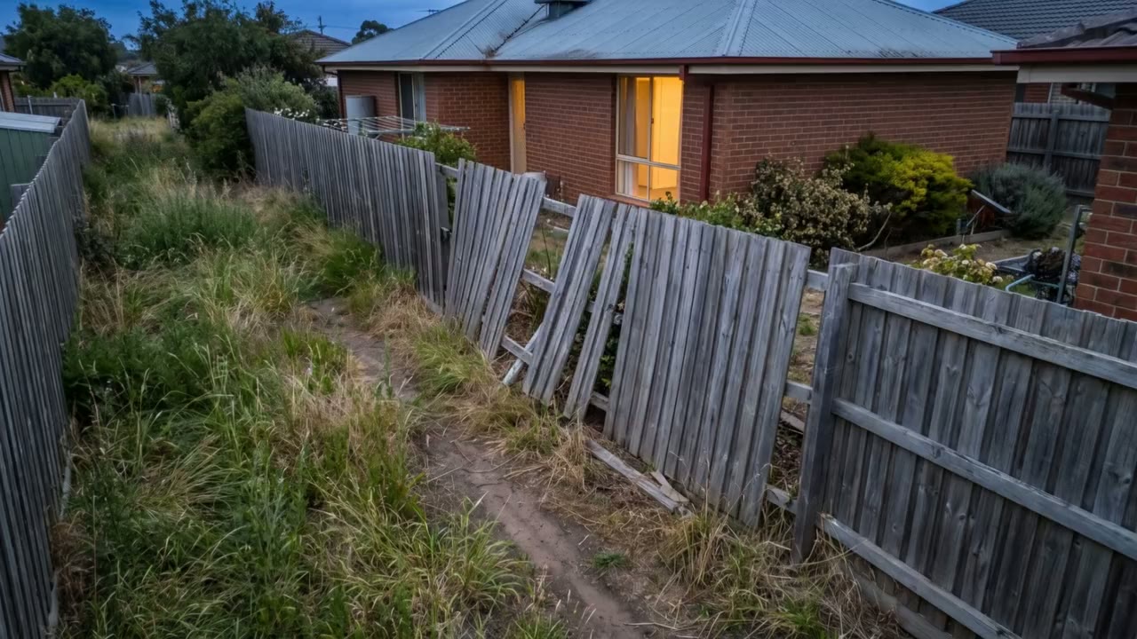 Leaning old timber fence before removal